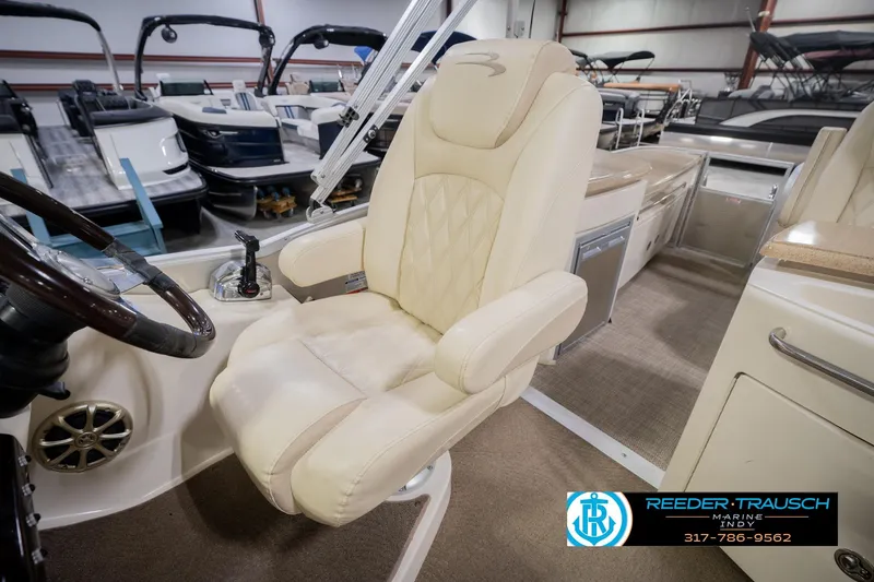 Slide: The Image of Captain's chair in 2013 Bennington 2550 RBR pontoon boat, showroom setting. - 35