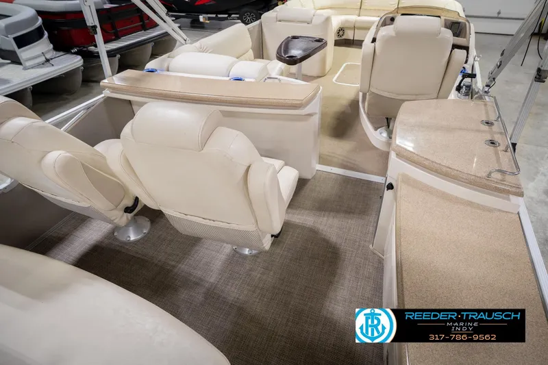 Slide: The Image of Interior of a 2013 Bennington 2550 RBR pontoon boat with beige seating and carpet. - 16