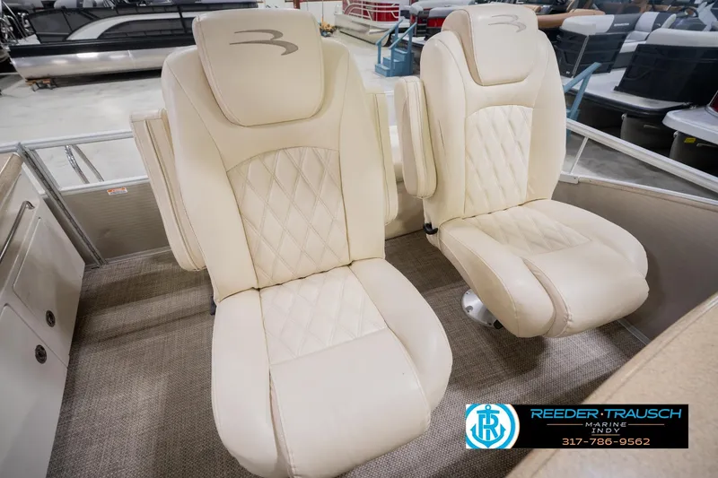 Slide: The Image of Luxurious beige seats on a 2013 Bennington 2550 RBR pontoon boat, showroom display. - 52