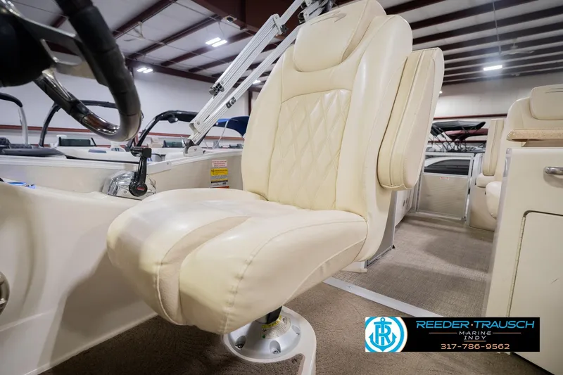 Slide: The Image of 2013 Bennington 2550 RBR boat interior with cream leather captain's chair. - 48