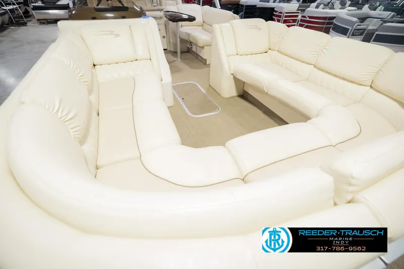 Slide: The Image of Luxurious seating on a 2013 Bennington 2550 RBR pontoon boat, featuring cream upholstery. - 14