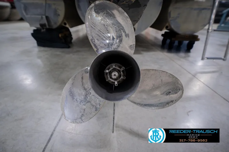 Slide: The Image of Propeller of a 2013 Bennington 2550 RBR boat in a workshop setting. - 65