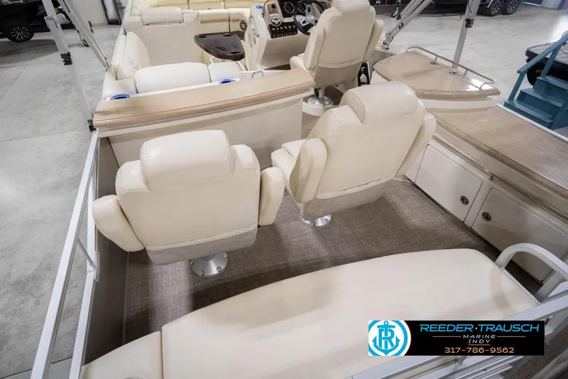 Slide: The Image of Interior of a 2013 Bennington 2550 RBR boat with beige seating and helm. - 17