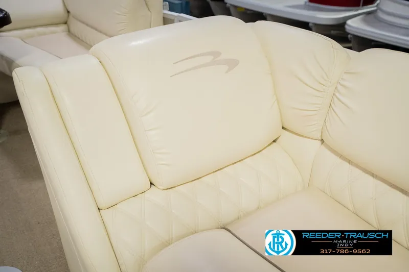 Slide: The Image of Cream leather seating on a 2013 Bennington 2550 RBR boat, featuring elegant stitching. - 28