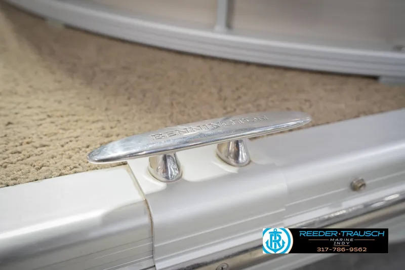 Slide: The Image of 2013 Bennington 2550 RBR boat cleat on carpeted deck, Reeder-Trausch Marine logo visible. - 69