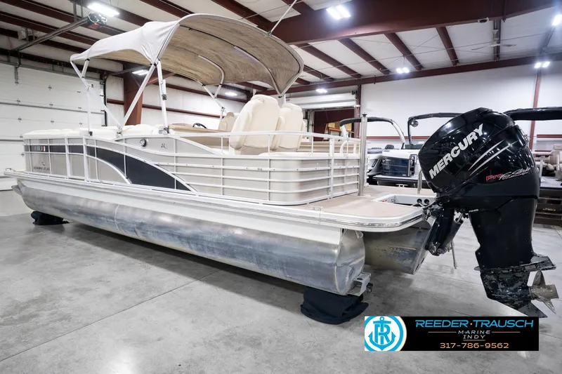 Slide: The Image of 2013 Bennington 2550 RBR pontoon boat with Mercury outboard in indoor showroom. - 10