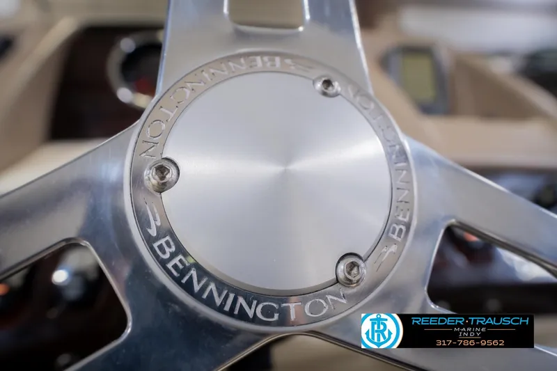 Slide: The Image of Close-up of a 2013 Bennington 2550 RBR steering wheel with logo. - 40