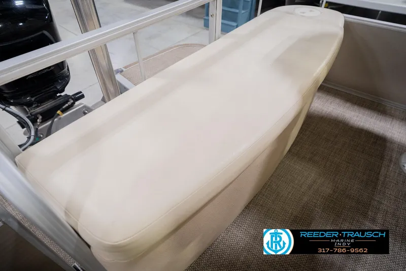Slide: The Image of Bennington 2550 RBR 2013 boat seat with beige upholstery and visible motor. - 53