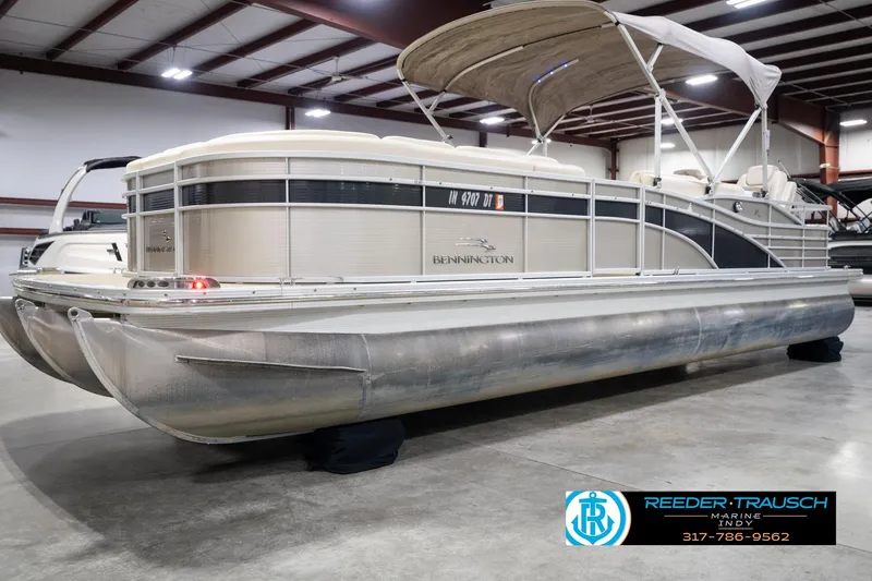 Slide: The Image of 2013 Bennington 2550 RBR pontoon boat in indoor showroom, side view. - 2