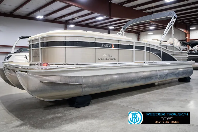 Slide: The Image of 2013 Bennington 2550 RBR pontoon boat in indoor showroom, side view. - 1