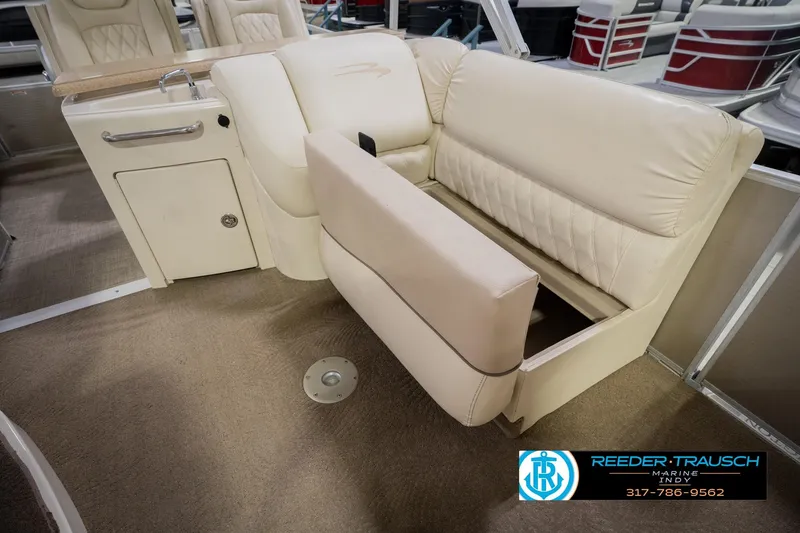 Slide: The Image of 2013 Bennington 2550 RBR boat interior with beige seating and storage compartment. - 33