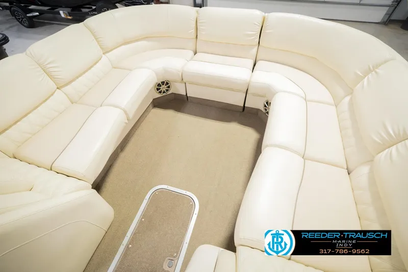 Slide: The Image of Luxurious seating on a 2013 Bennington 2550 RBR pontoon boat, featuring cream leather upholstery. - 50