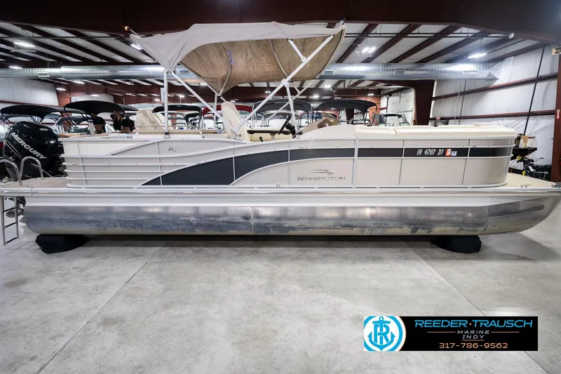 Slide: The Image of 2013 Bennington 2550 RBR pontoon boat in indoor showroom, side view. - 6
