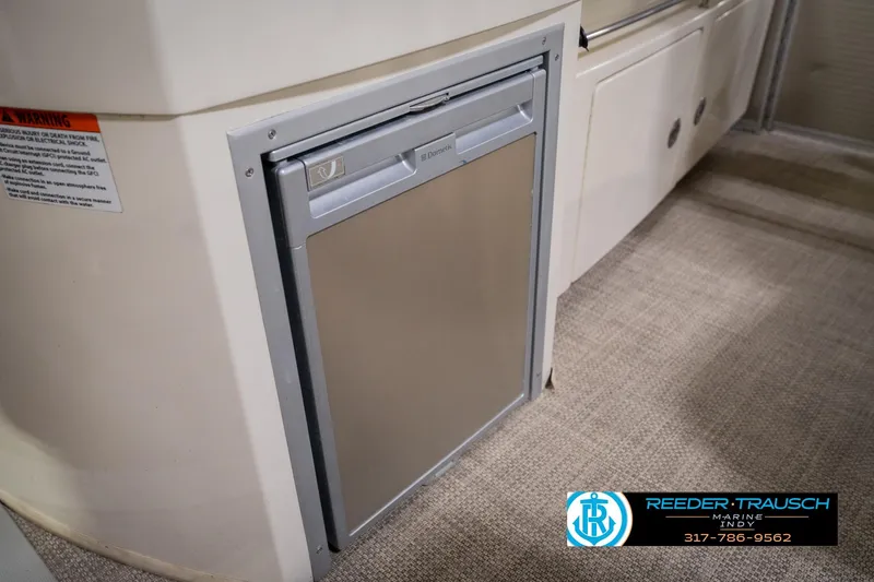 Slide: The Image of 2013 Bennington 2550 RBR boat interior with compact refrigerator. - 36