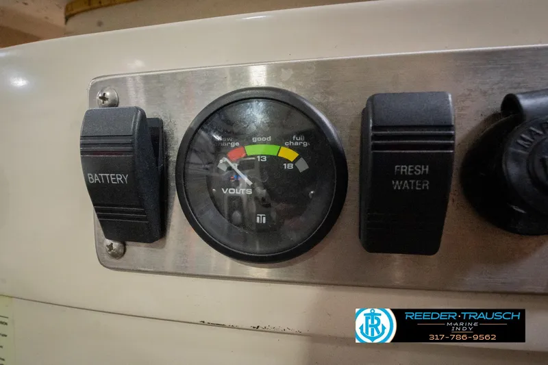 Slide: The Image of 2013 Bennington 2550 RBR dashboard with battery and fresh water controls. - 59
