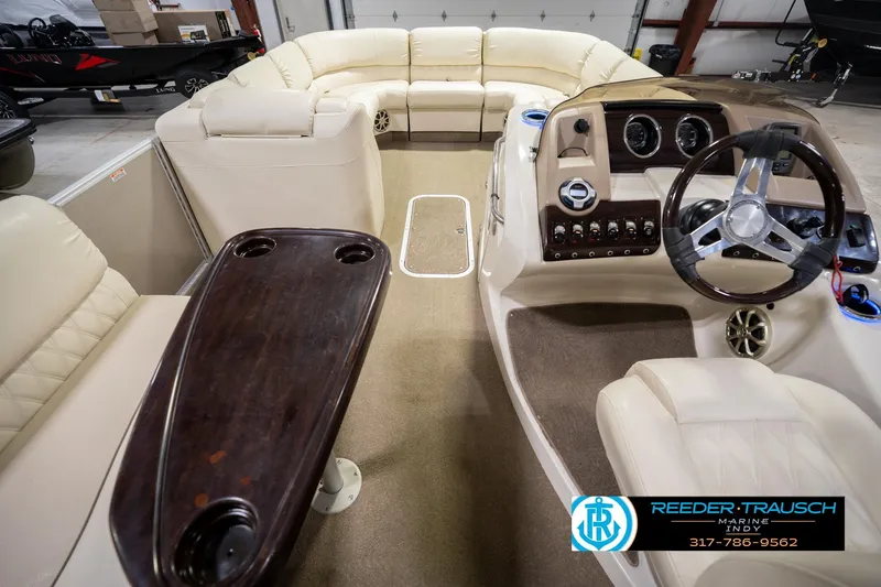 Slide: The Image of Interior of 2013 Bennington 2550 RBR boat with luxurious seating and steering console. - 24