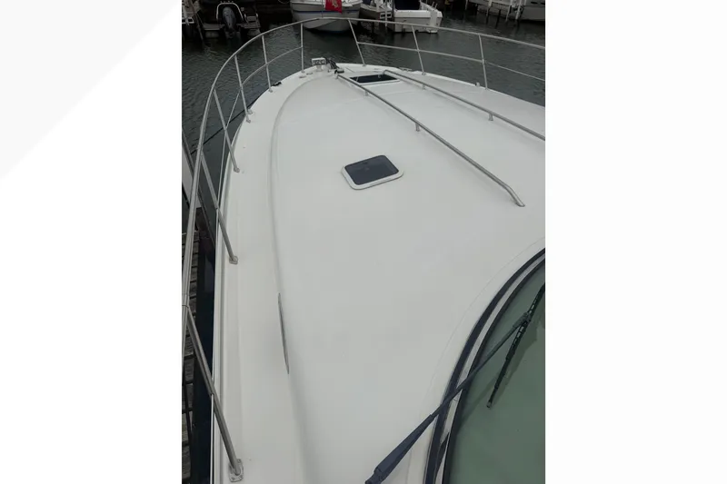 Slide: The Image of 1998 Sea Ray Sundancer 400 yacht deck with railing, docked at marina. - 1