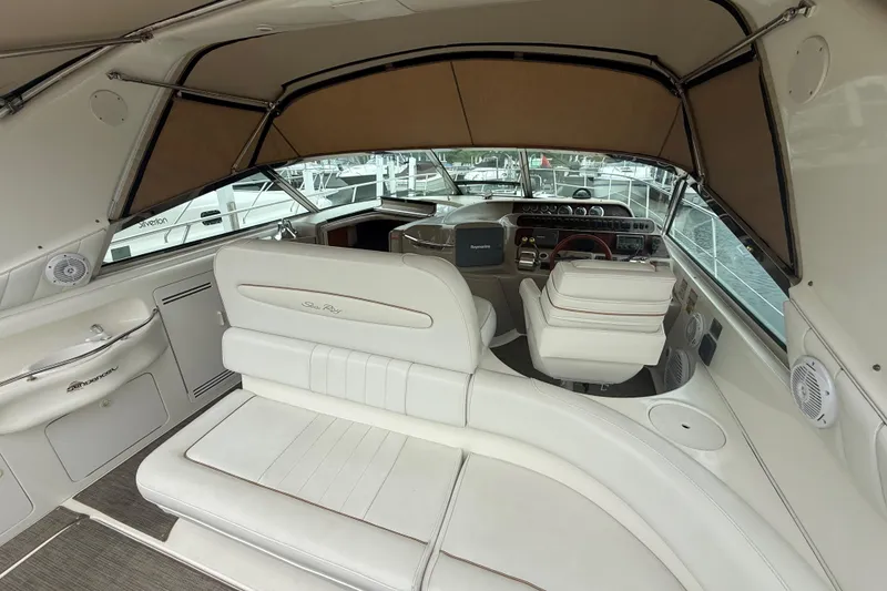 Slide: The Image of Interior of a 1998 Sea Ray Sundancer 400 yacht with white seating and helm. - 12
