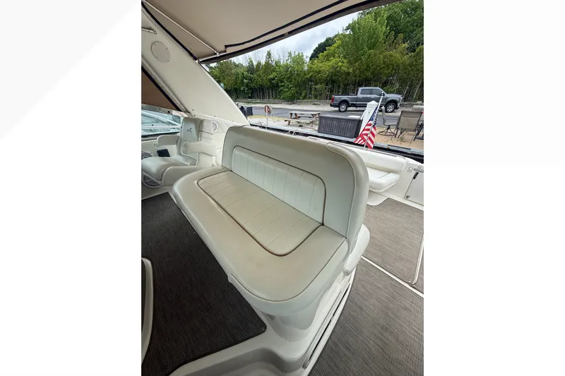 Slide: The Image of 1998 Sea Ray Sundancer 400 interior with white seating and American flag. - 16