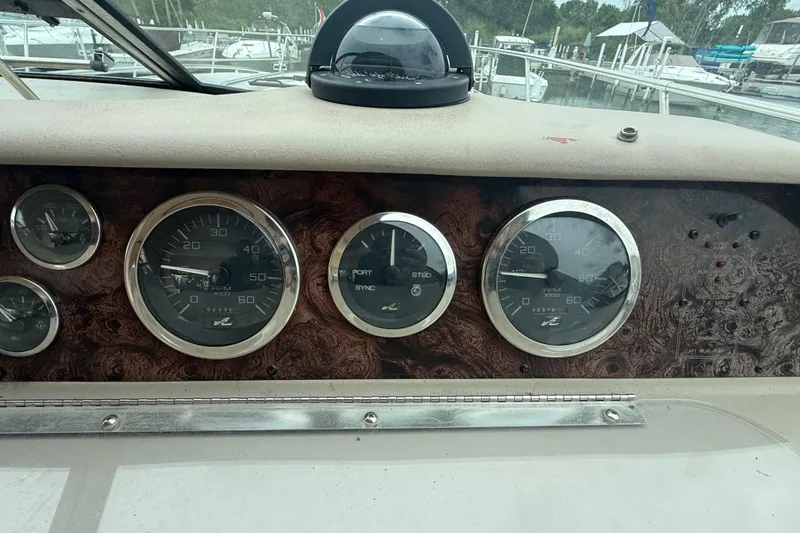 Slide: The Image of Dashboard of a 1998 Sea Ray Sundancer 400 with gauges and compass. - 23