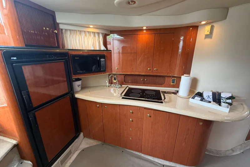 Slide: The Image of Luxurious 1998 Sea Ray Sundancer 400 yacht kitchen with wood cabinetry and modern appliances. - 26