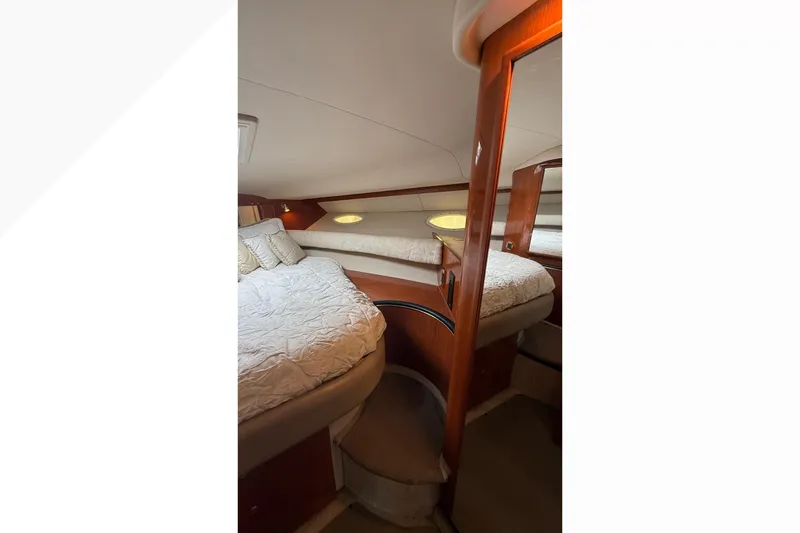 Slide: The Image of Interior cabin of 1998 Sea Ray Sundancer 400 yacht with cozy bedding and wooden accents. - 30