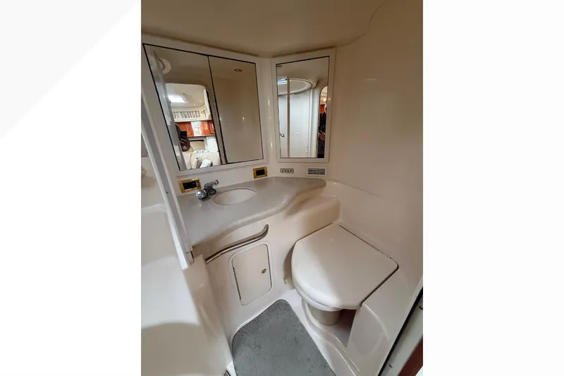 Slide: The Image of 1998 Sea Ray Sundancer 400 bathroom with sink, mirror, and toilet. - 33