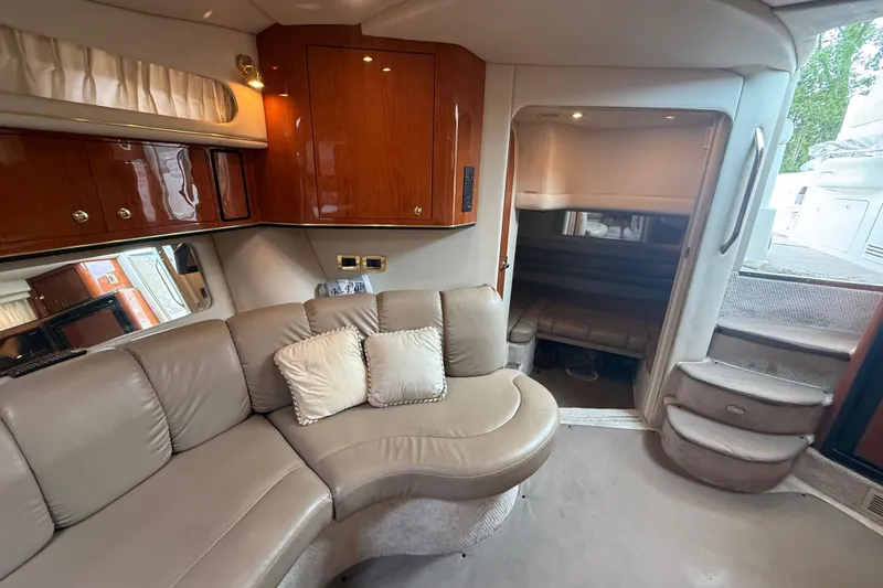 Slide: The Image of Interior of 1998 Sea Ray Sundancer 400 yacht with plush seating and elegant wood cabinetry. - 35