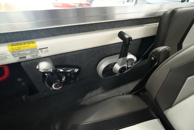 Slide: The Image of Interior view of a 2027 Thunder Jet 210 Luxor Limited with control levers and gray seating. - 21
