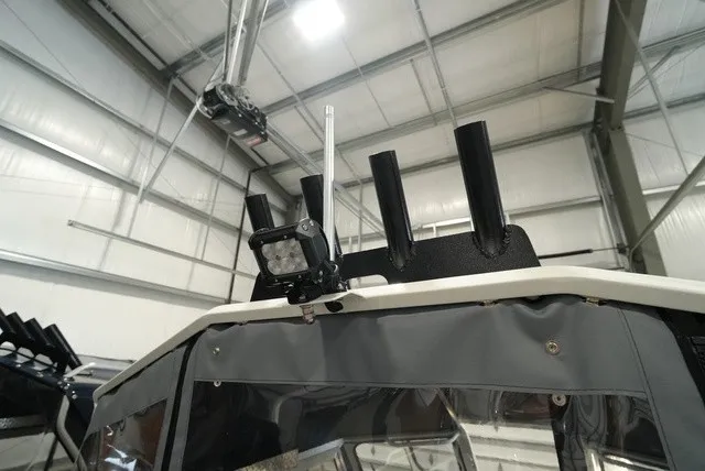 Slide: The Image of The image shows the top of a Thunder Jet 210 Luxor Limited with fishing rod holders and a light. - 8
