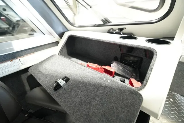 Slide: The Image of Interior view of a Thunder Jet 210 Luxor Limited with gray storage compartment and cup holders. - 23