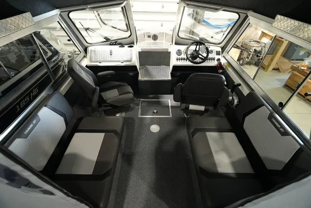 Slide: The Image of Interior of a Thunder Jet 210 Luxor Limited boat with gray seating and a modern cockpit. - 15