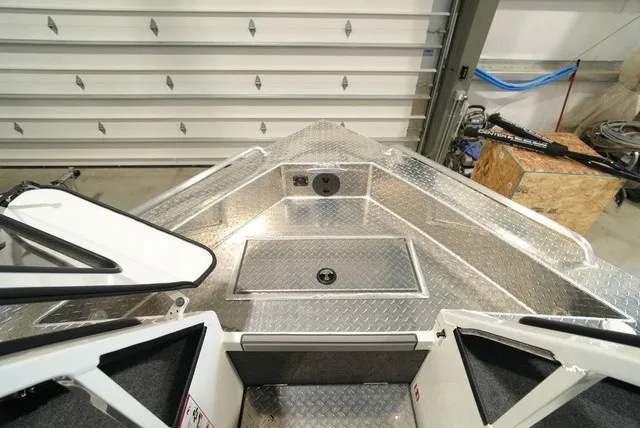 Slide: The Image of The image shows the bow of a Thunder Jet 210 Luxor Limited with aluminum decking and storage compartments. - 27