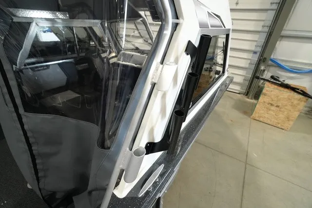 Slide: The Image of Side view of a Thunder Jet 210 Luxor Limited with fishing rod holders. - 9