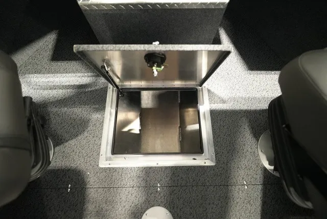 Slide: The Image of An open floor compartment in a boat with gray carpet and two seats. - 25