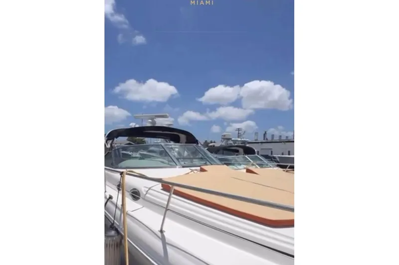 The Image of 2001 Sea Ray 380 Sundancer yacht docked under a clear blue sky in Miami. - 0