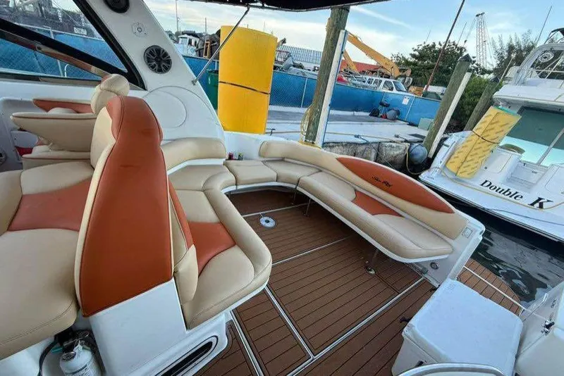 Slide: The Image of 2001 Sea Ray 380 Sundancer yacht interior with tan and orange seating, docked at marina. - 3