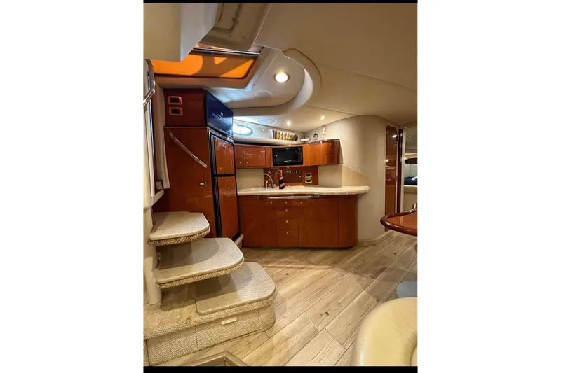 Slide: The Image of Luxurious interior of 2001 Sea Ray 380 Sundancer yacht with modern kitchen and elegant design. - 5