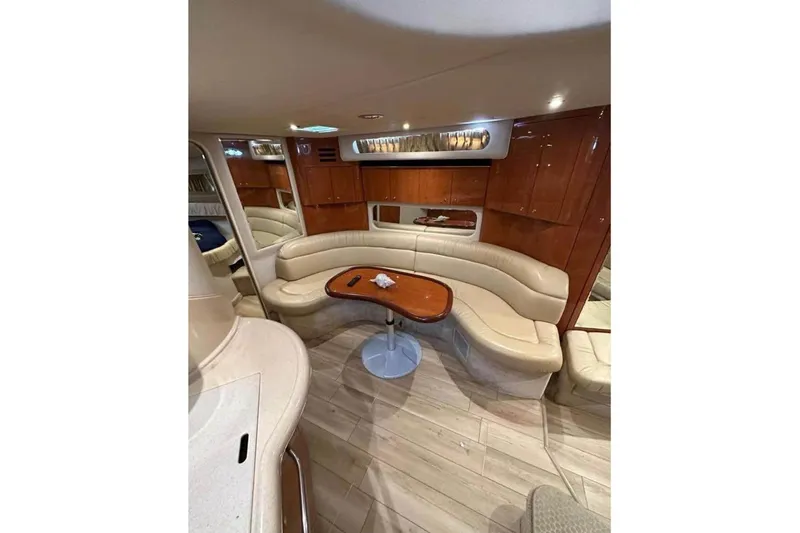 Slide: The Image of Luxurious interior of 2001 Sea Ray 380 Sundancer yacht with curved seating and wooden accents. - 6
