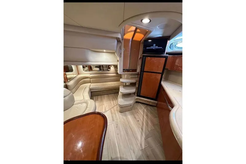 Slide: The Image of Luxurious interior of 2001 Sea Ray 380 Sundancer yacht with elegant seating and modern amenities. - 8