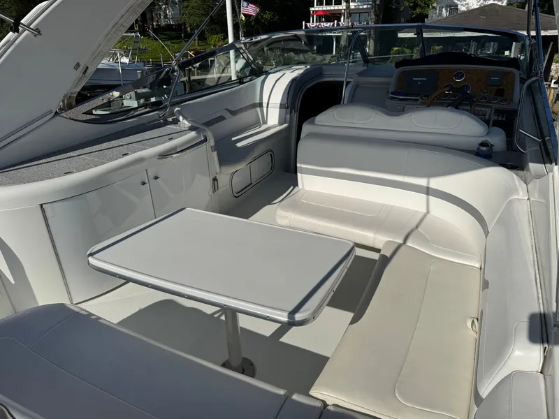 Slide: The Image of Interior of a luxury yacht with white seating and a table. - 10