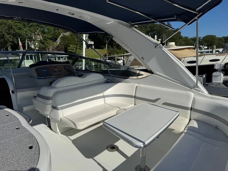 Slide: The Image of The boat features a white seating area and table under a blue canopy. - 11