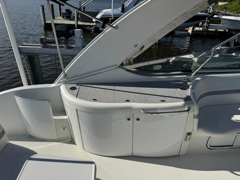 Slide: The Image of The boat features a sleek, modern design with white seating and a gray deck. - 12