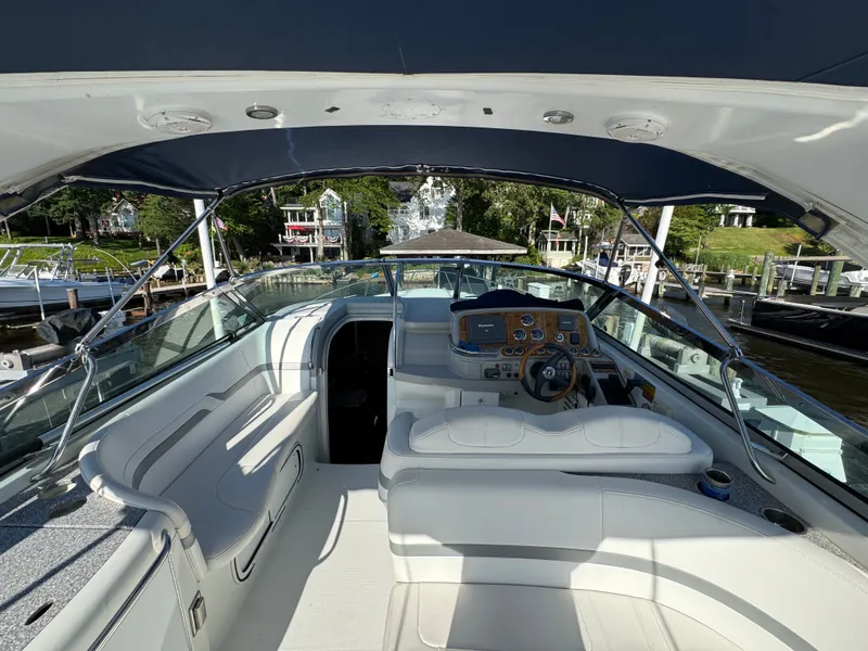 Slide: The Image of The cockpit of a luxury yacht with white seating and a sleek helm station. - 18