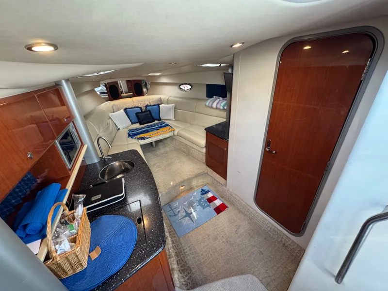 Slide: The Image of Interior of a luxury yacht with seating area, kitchenette, and wooden doors. - 27