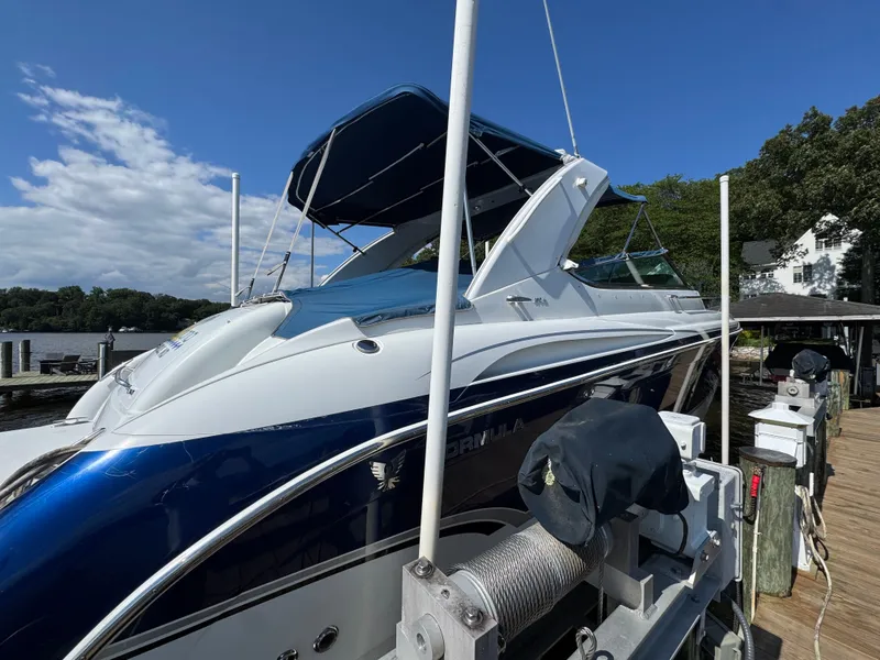 Slide: The Image of A blue and white motorboat docked at a wooden pier. - 3