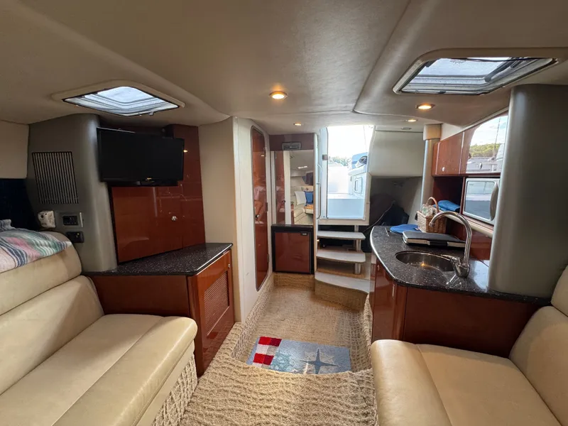 Slide: The Image of Interior of a luxury yacht with seating area, TV, and kitchenette. - 32