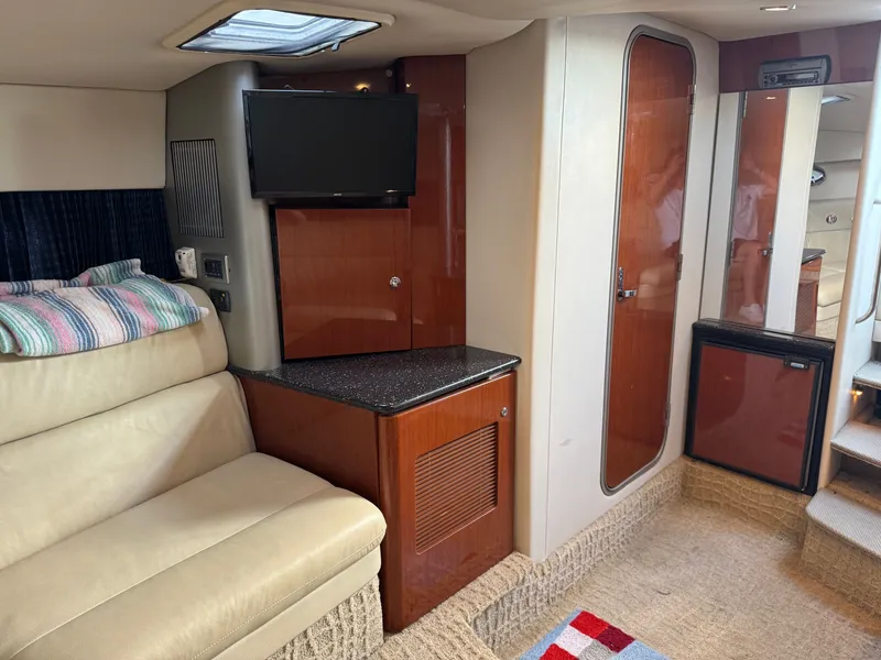 Slide: The Image of Interior of a yacht with a sofa, TV, and wooden cabinetry. - 33