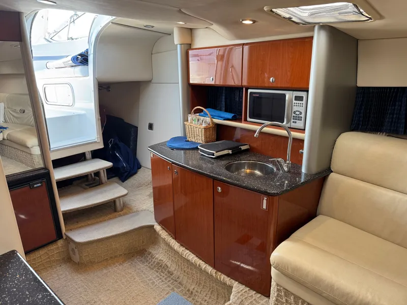 Slide: The Image of Interior of a yacht with kitchenette, microwave, and seating area. - 34