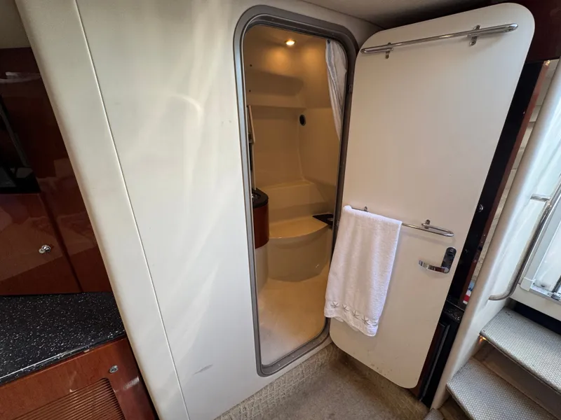 Slide: The Image of Interior of a yacht with an open bathroom door and towel. - 37